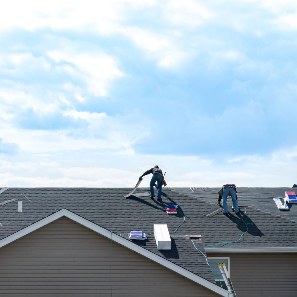 4,Construction,Workers,Fixing,Roof,Against,Clouds,Blue,Sky.,Roofer